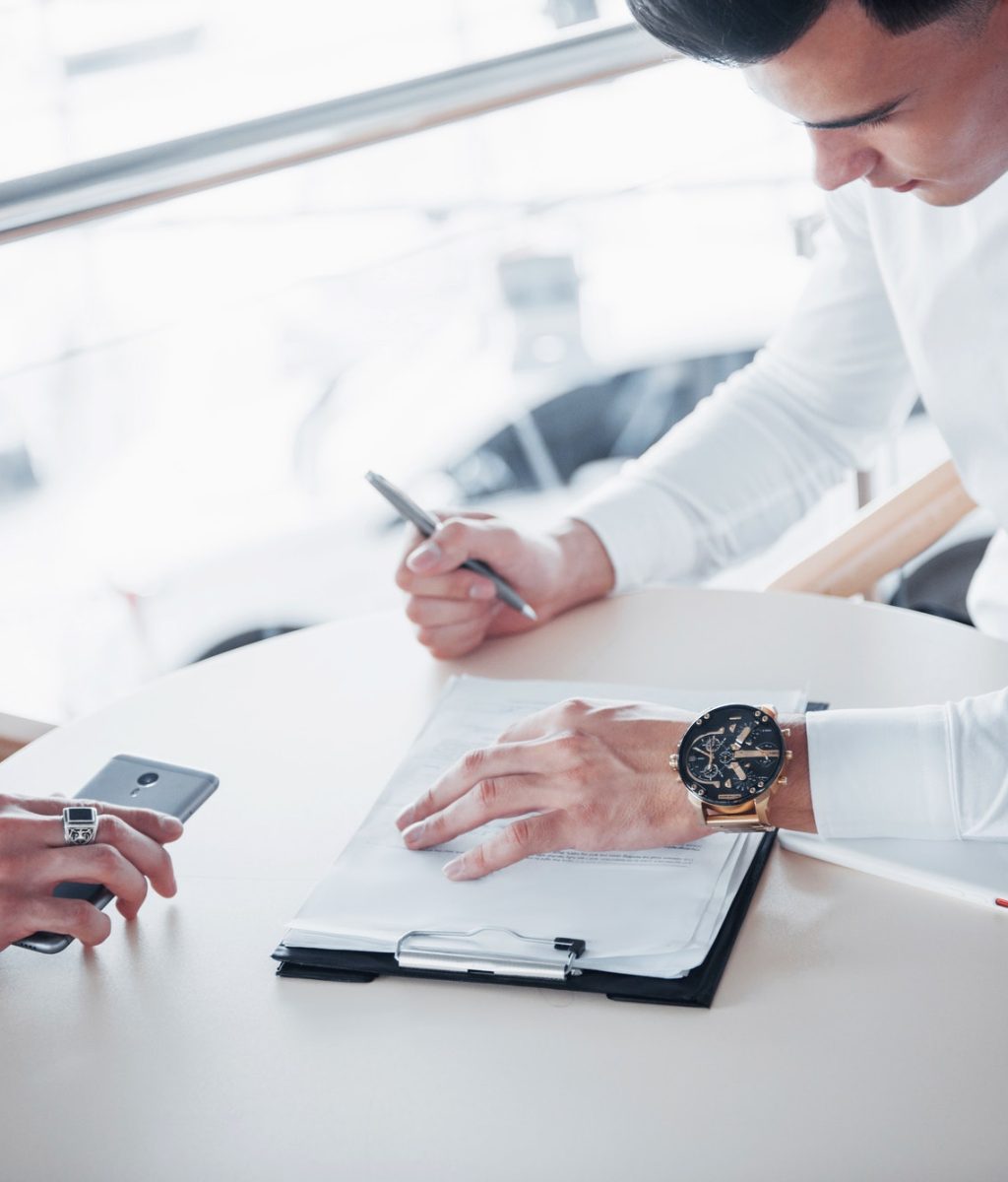 young-man-signs-documents-in-the-office-successful-sales.jpg